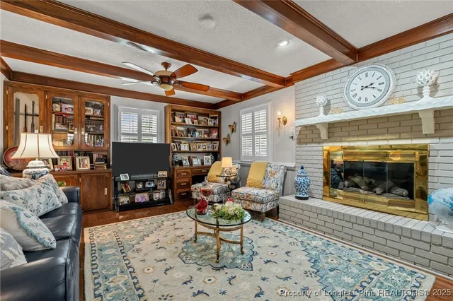 a living room with furniture a fireplace and a table