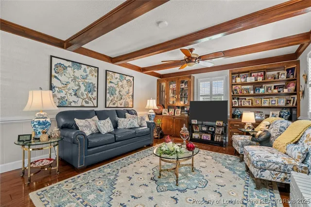 a living room with furniture a rug and a large window
