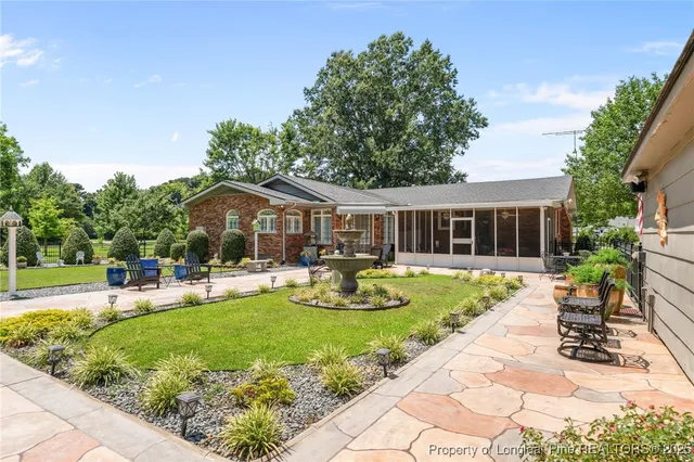 a front view of a house with garden and porch