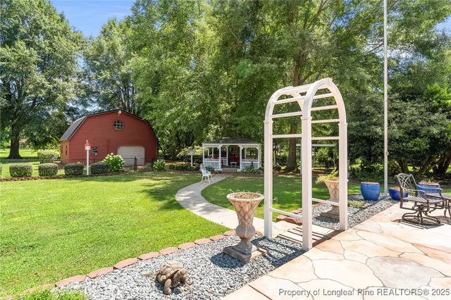 a view of a chair and table in backyard of the house