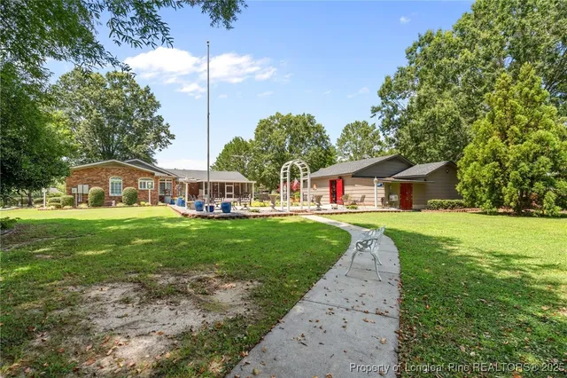 a view of a swimming pool and trees in the background