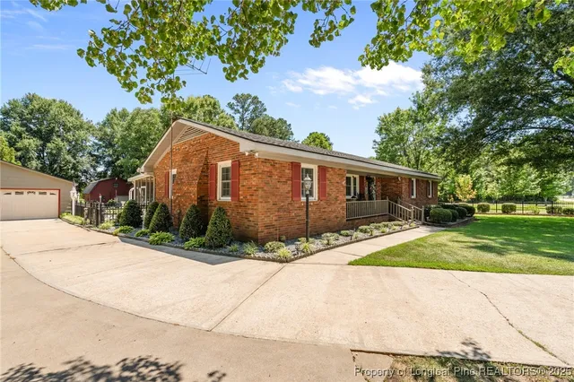 a house view with a sitting space and garden