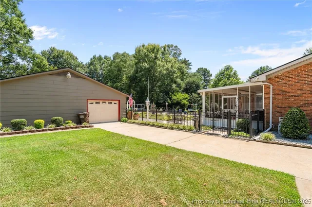 a view of a chair and table in backyard of the house