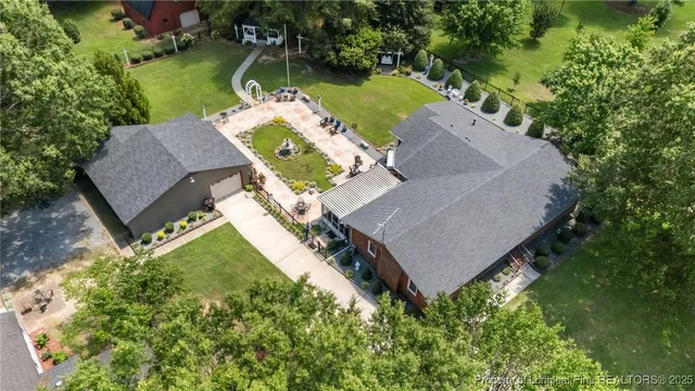an aerial view of a house with outdoor space and lake view