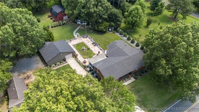 an aerial view of a house with garden space and a street view