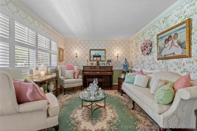 a living room with furniture a rug and a large window