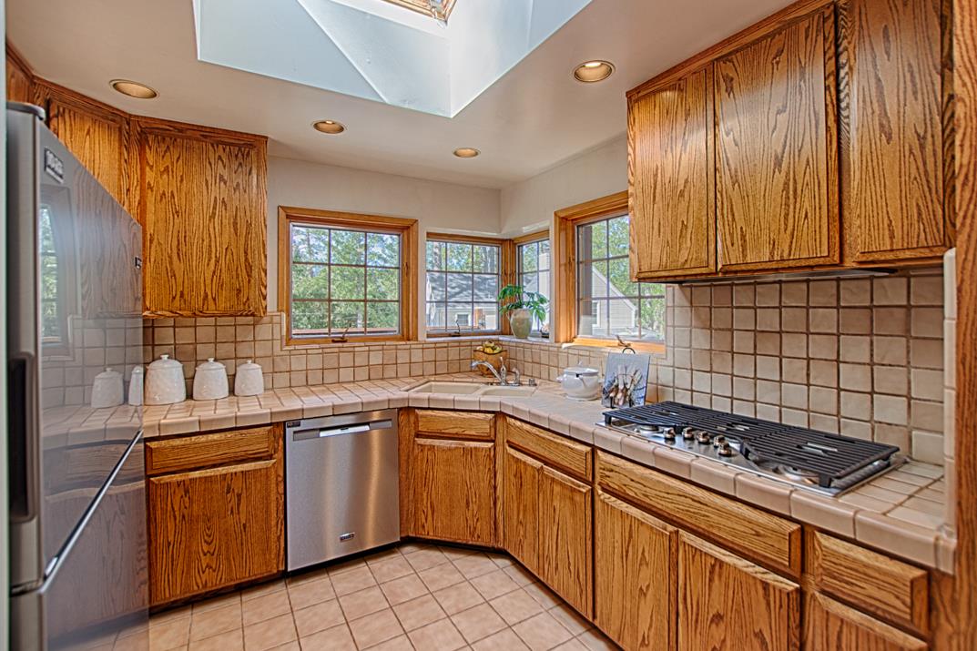 79 Pine Avenue Mount Hermon, CA 95041 - Photo 11 of 32 a kitchen with a sink stove and cabinets