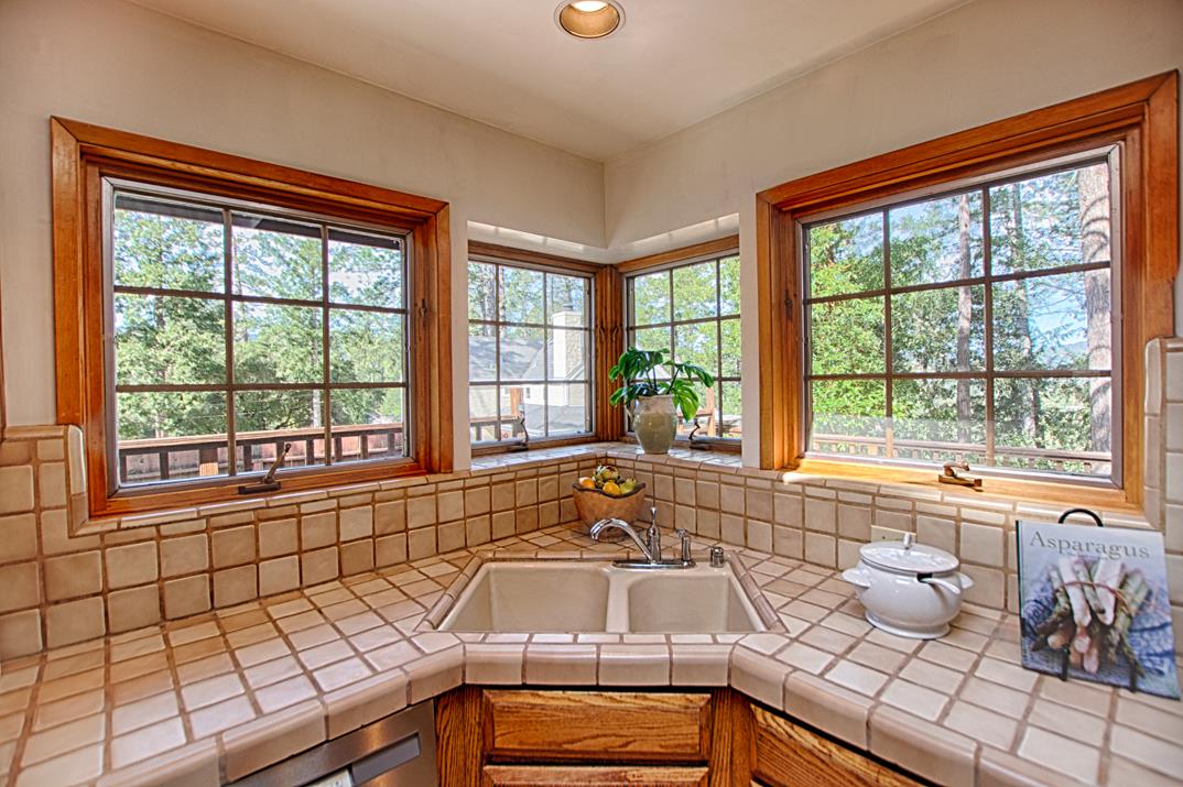79 Pine Avenue Mount Hermon, CA 95041 - Photo 10 of 32 a kitchen with a sink and large windows