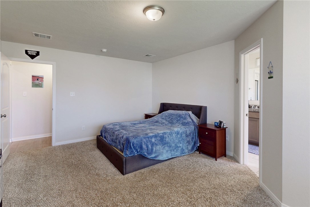 3719 Mckenzie Street Bryan, TX 77803 - Photo 15 of 20 a spacious bedroom with a bed and a table