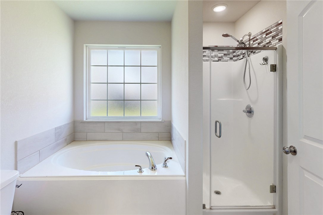 3719 Mckenzie Street Bryan, TX 77803 - Photo 17 of 20 a bathroom with a bathtub and a shower