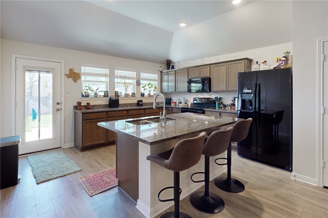 3719 Mckenzie Street Bryan, TX 77803 - Photo 7 of 20 a kitchen with center island and stainless steel appliances