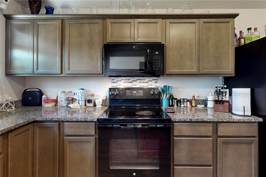 3719 Mckenzie Street Bryan, TX 77803 - Photo 9 of 20 a kitchen with granite countertop a sink stainless steel appliances and cabinets