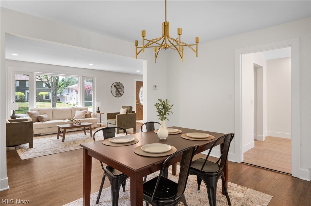 22625 Rye Road Shaker Heights, OH 44122 - Photo 9 of 38 Dining area featuring a gold-finish chandelier, wood-finish flooring, and white walls