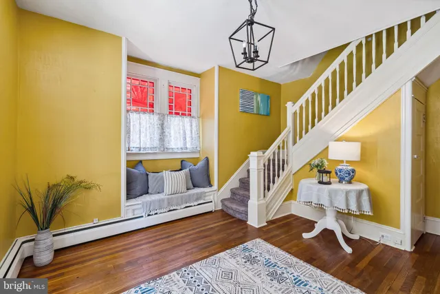 a view of entryway and hall with wooden floor