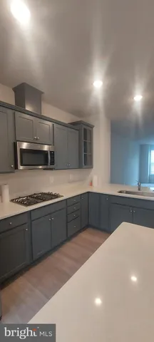 a large kitchen with a table and chairs