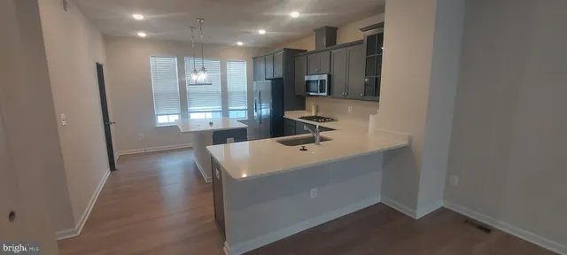 an empty room with windows and entryway