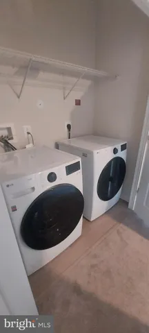 a view of a sink and washer dryer