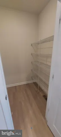 a view of a kitchen with a sink a microwave and a refrigerator