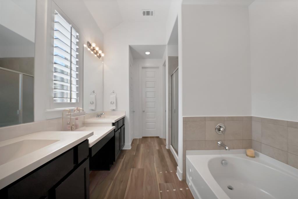 1709 Shetland Road Aubrey, TX 76227 - Photo 19 of 35 a spacious bathroom with a tub sink shower and two mirror