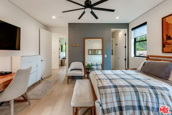 a bedroom with a bed and wooden floor
