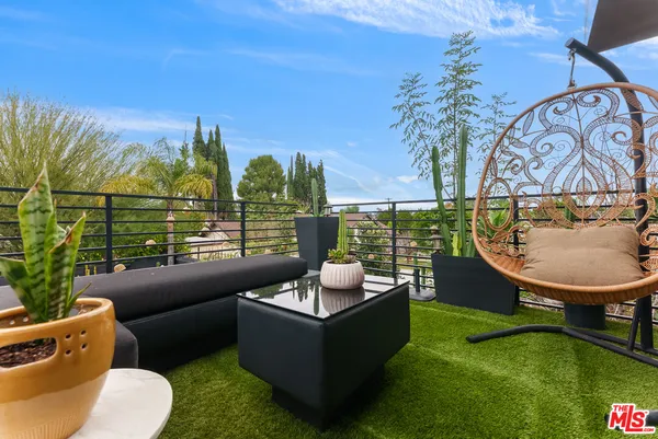 a view of a patio with table and chairs with wooden fence and plants