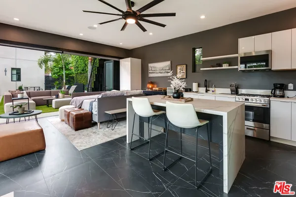 a view of a swimming pool with chairs and a table
