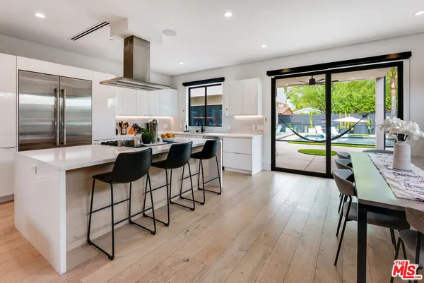 a kitchen that has a sink and a stove in it