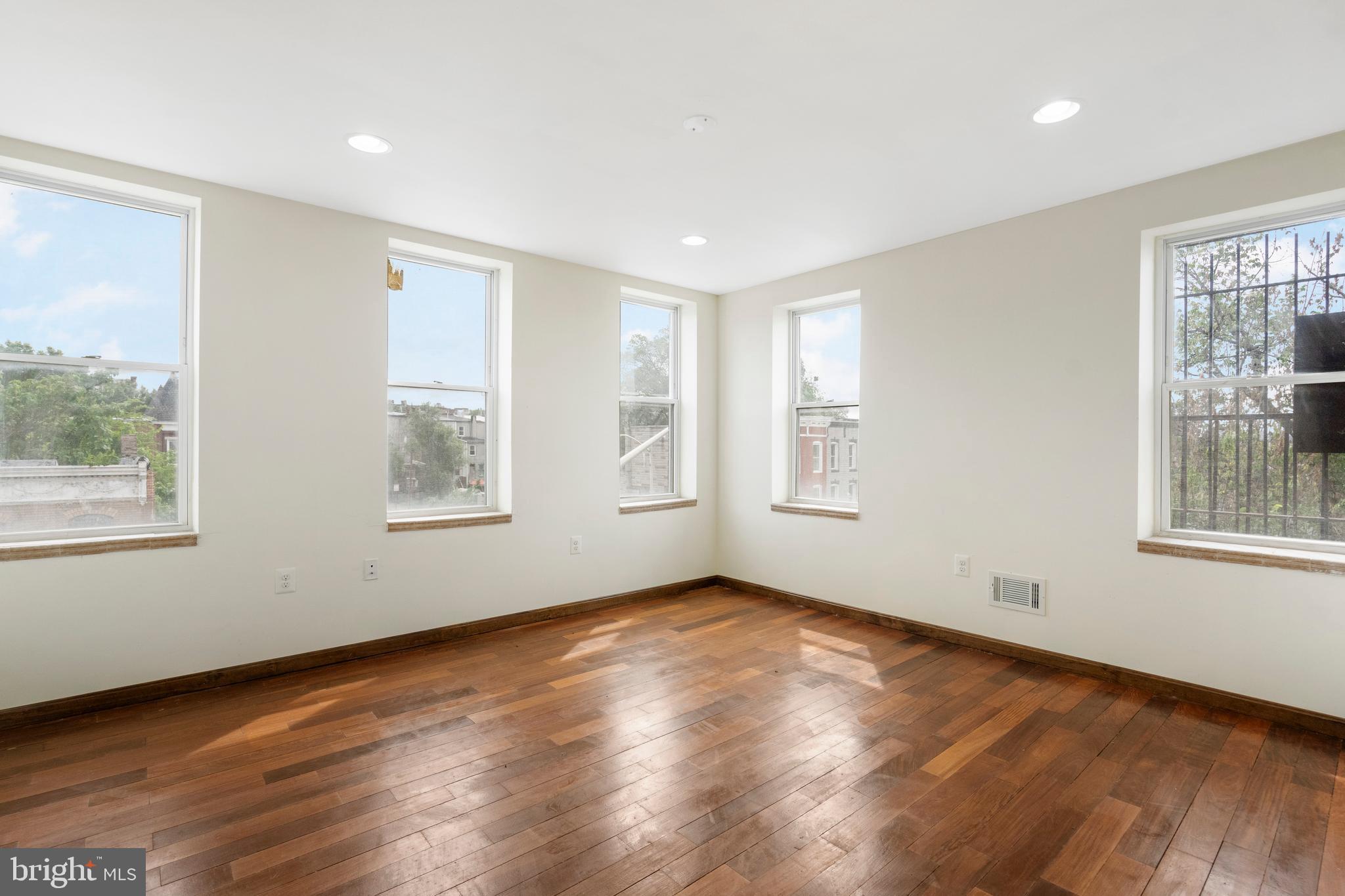 2400 Druid Hill Avenue Baltimore, MD 21217 - Photo 12 of 27 a view of an empty room with wooden floor and a window