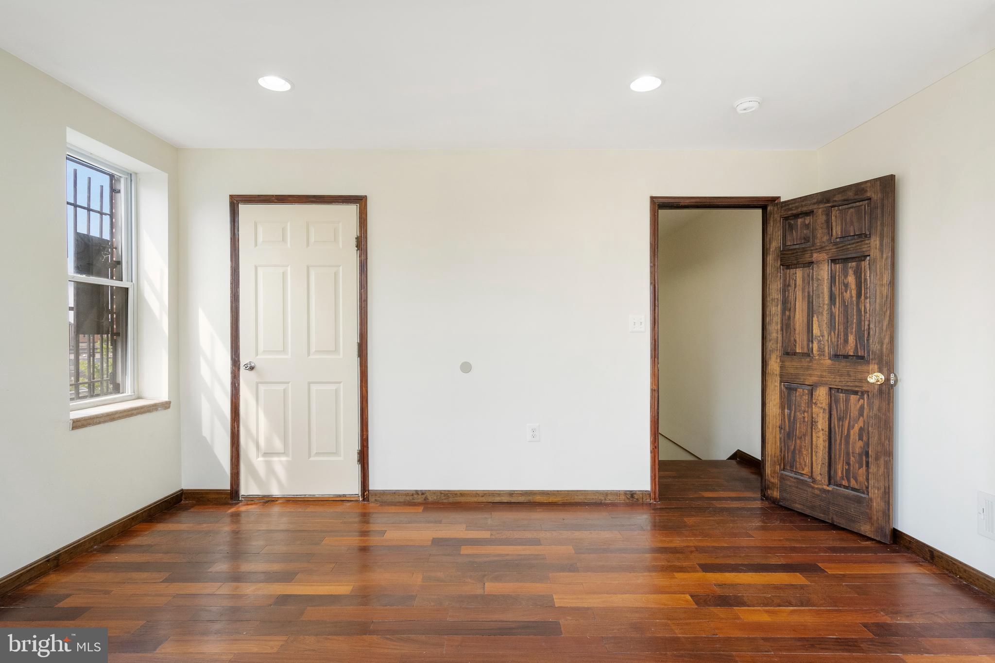 2400 Druid Hill Avenue Baltimore, MD 21217 - Photo 13 of 27 a view of an empty room with wooden floor and a window
