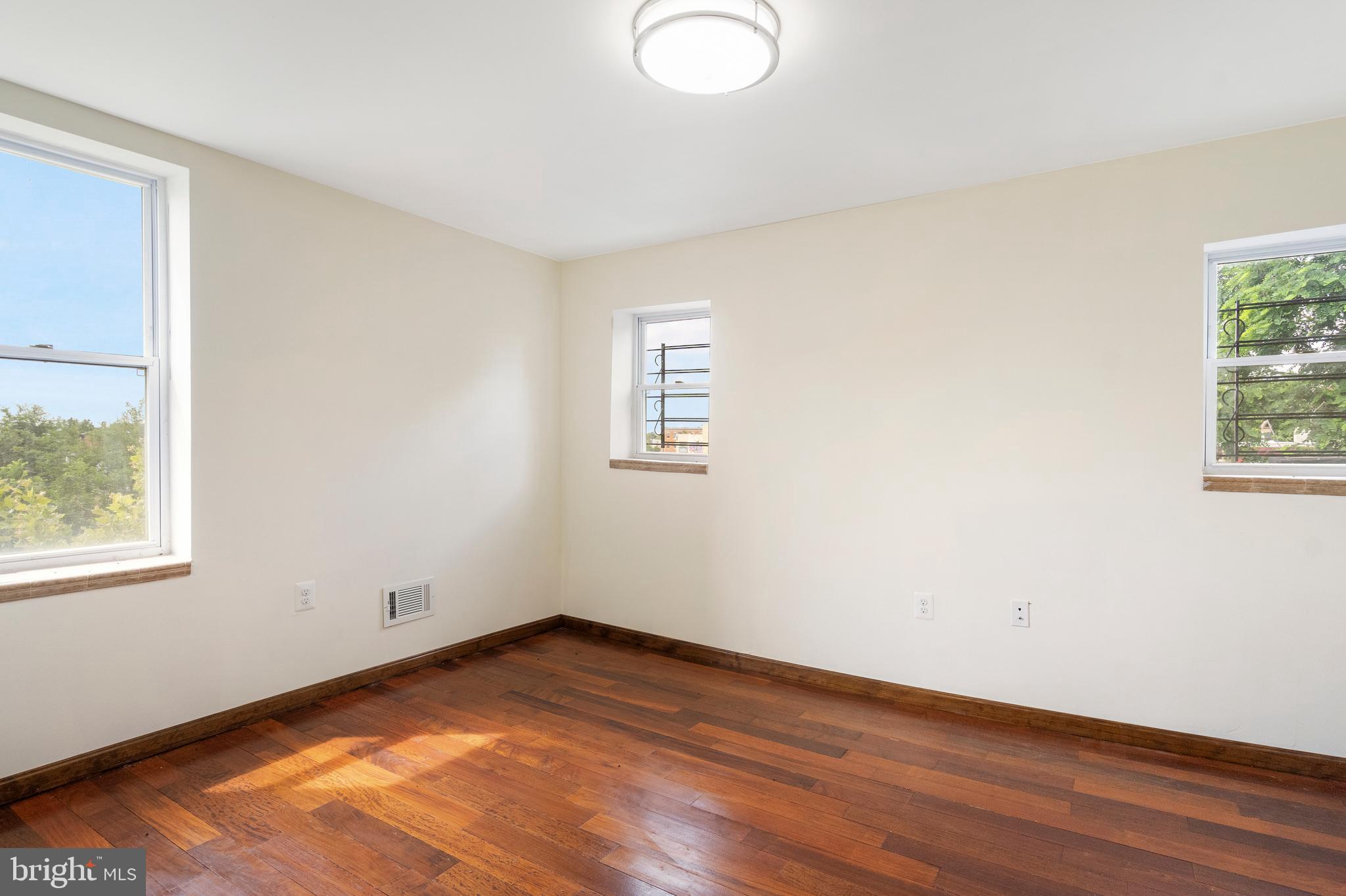 2400 Druid Hill Avenue Baltimore, MD 21217 - Photo 15 of 27 an empty room with wooden floor and windows