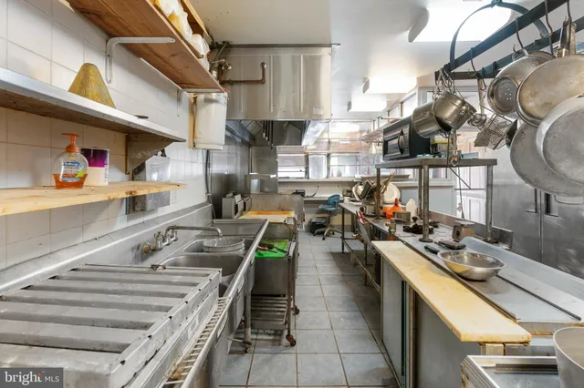 a kitchen with lots of counter top space and stainless steel appliances