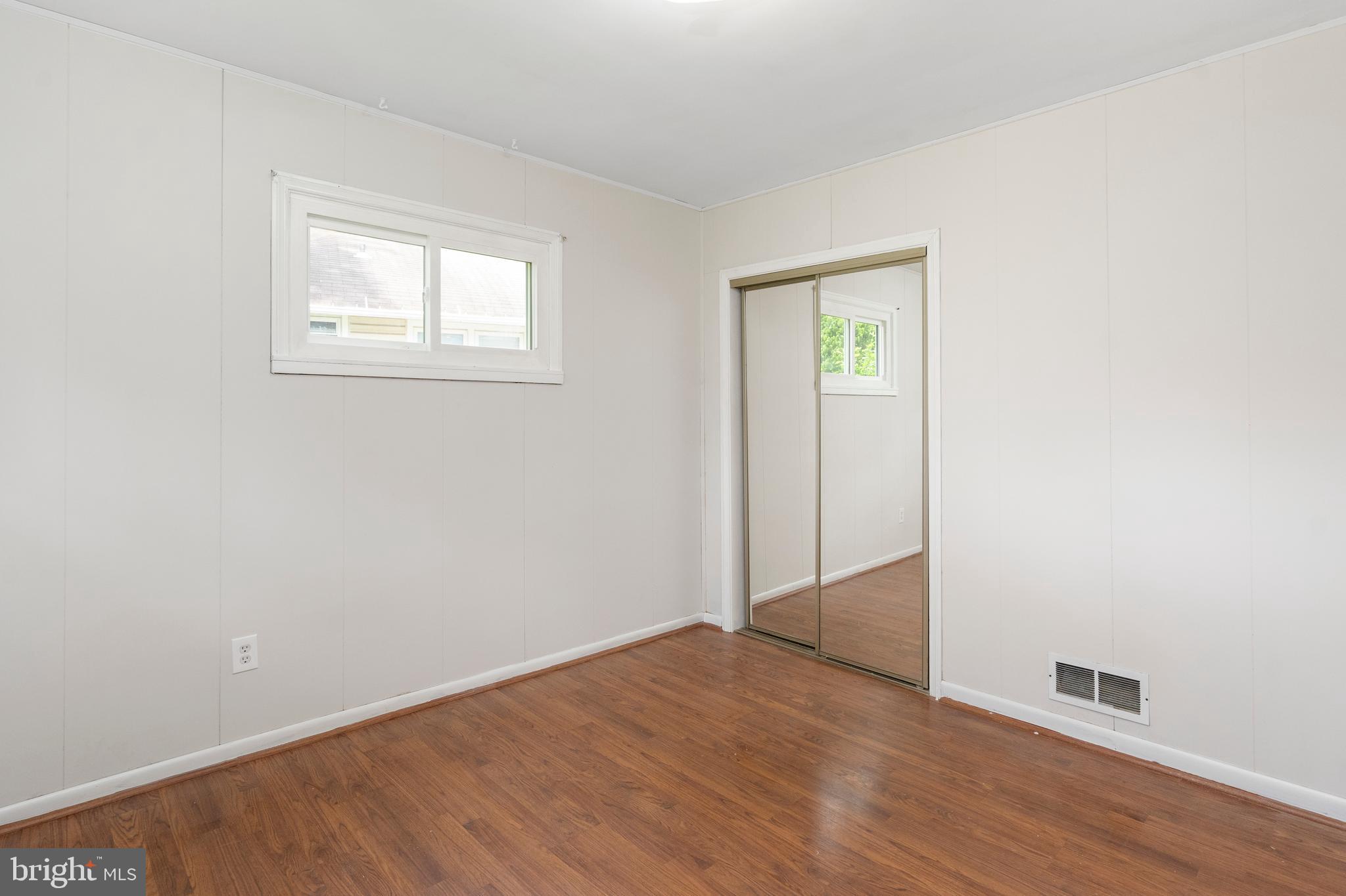 2400 Druid Hill Avenue Baltimore, MD 21217 - Photo 9 of 27 an empty room with wooden floor and windows