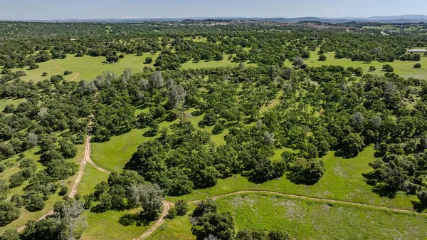 an aerial view of a houses with a yard