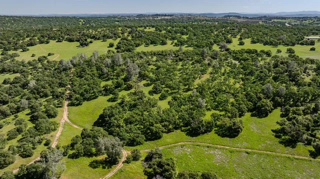 an aerial view of a houses with a yard