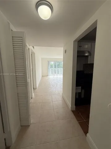 a kitchen with granite countertop white cabinets and black appliances