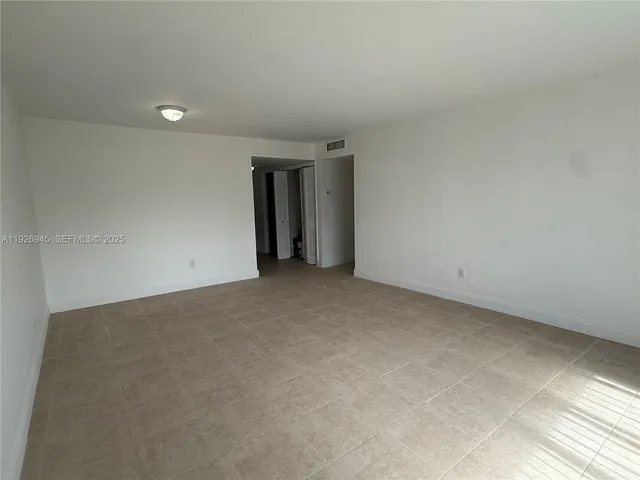 a white kitchen with granite countertop white cabinets and sink