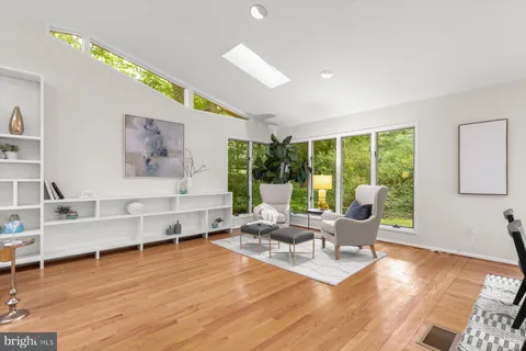 a living room with lots of furniture and a large window