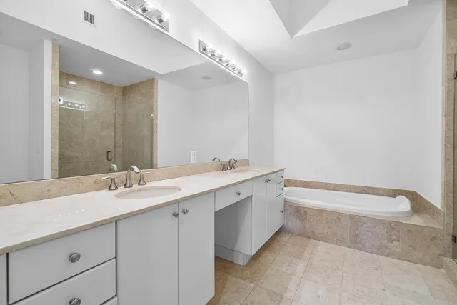 a bathroom with a bathtub and shower