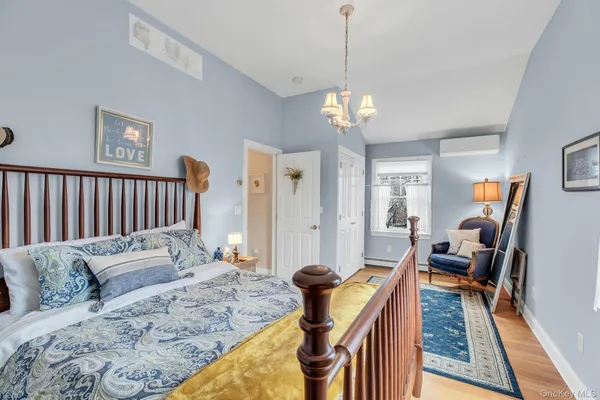a living room with furniture wooden floor and a chandelier