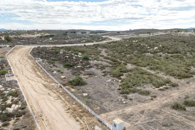 a view of a yard with wooden fence