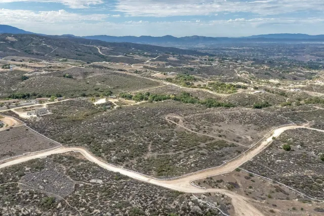a view of a yard with wooden fence
