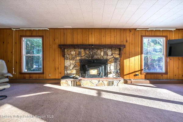 a front view of a house with a yard covered in snow