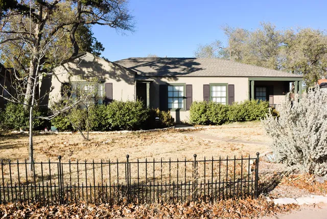 a view of a house with a yard covered with snow in front of house