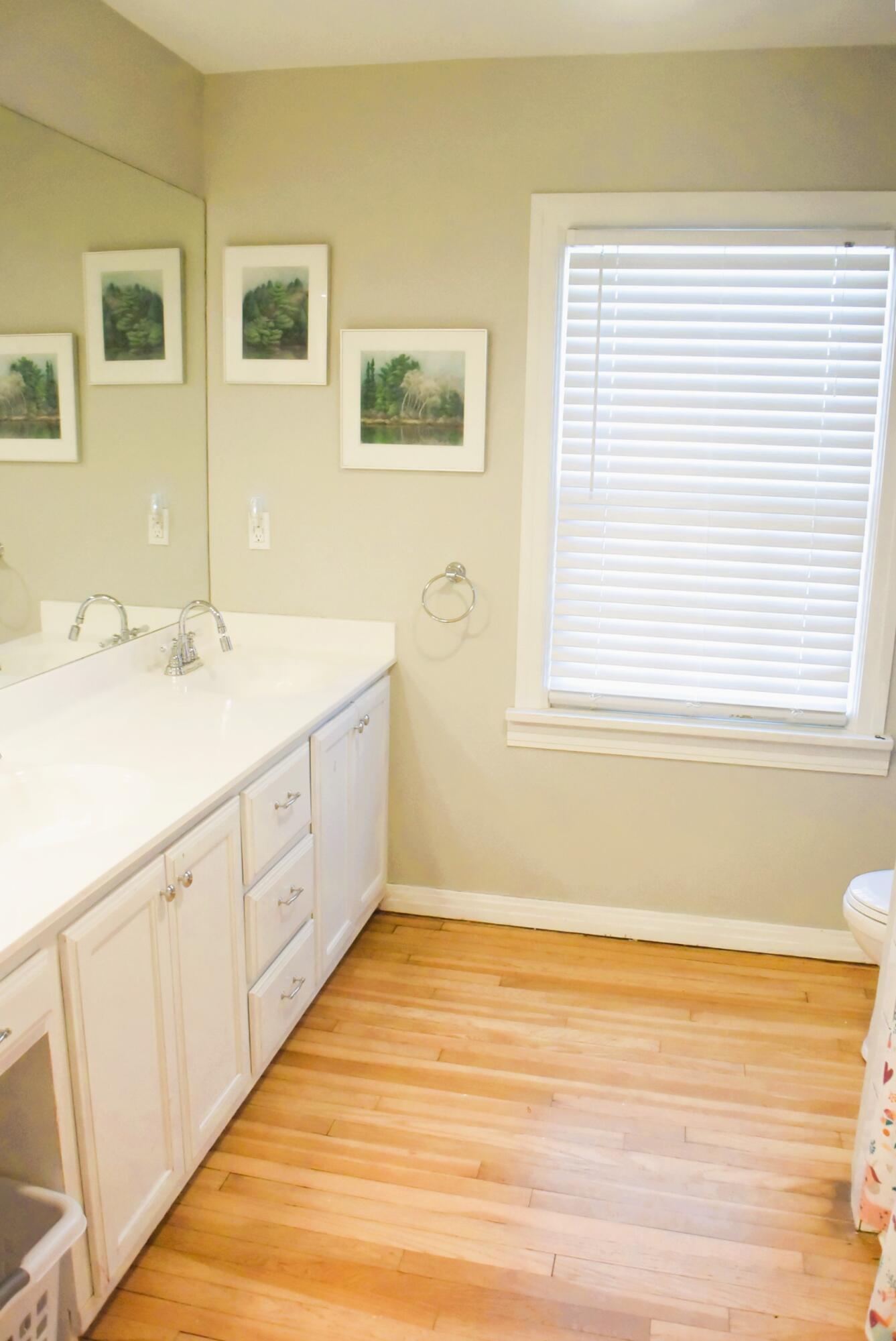 2508 24th Street Lubbock, TX 79410 - Photo 13 of 14 a spacious bathroom with a granite countertop sink and a window