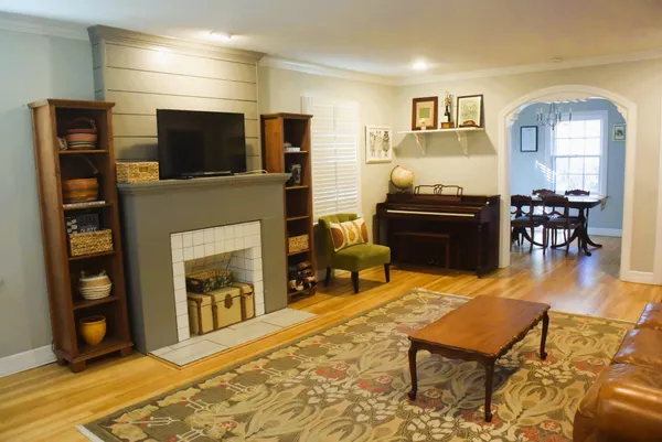 a living room with fireplace furniture and a flat screen tv