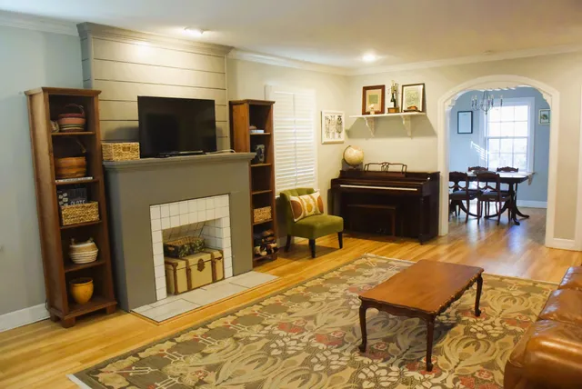a living room with fireplace furniture and a flat screen tv