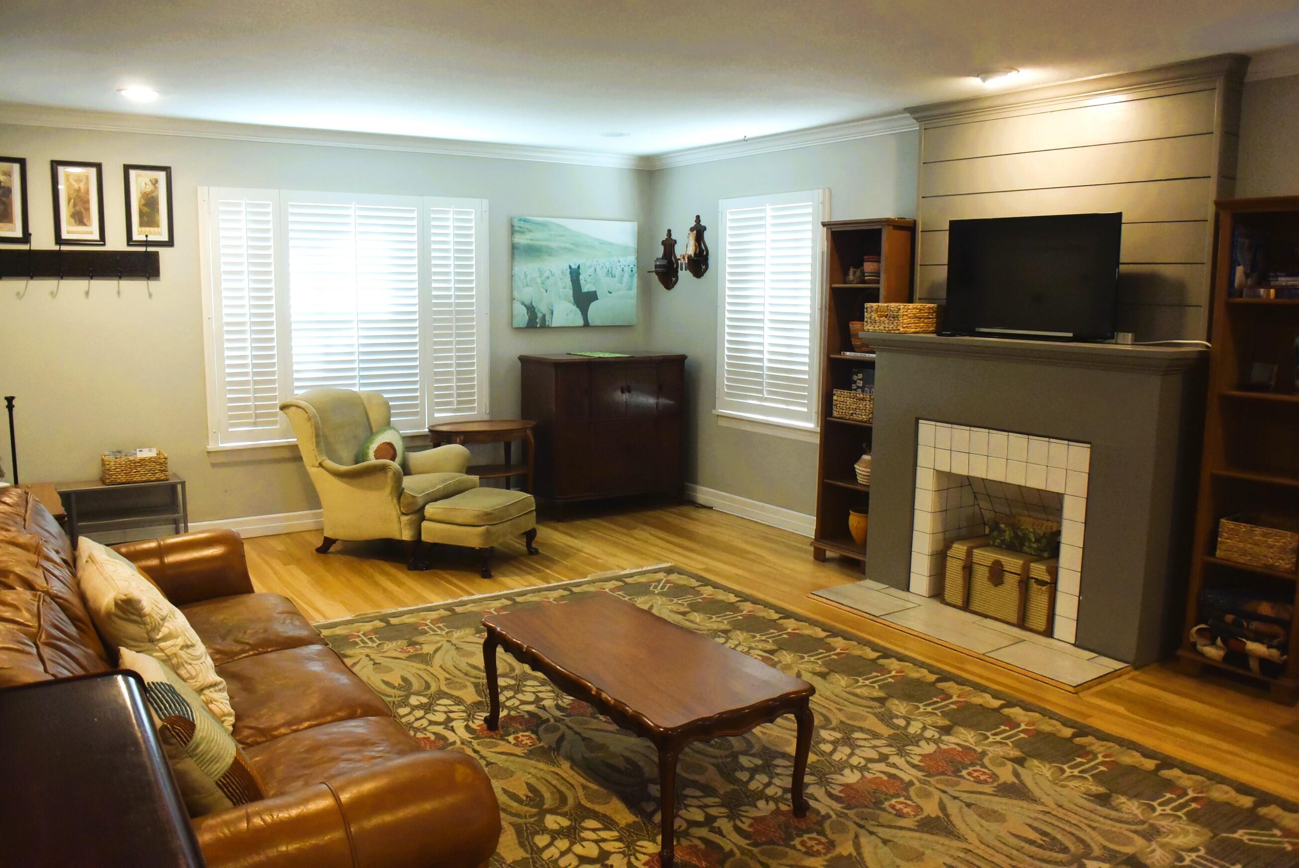 2508 24th Street Lubbock, TX 79410 - Photo 4 of 14 a living room with furniture a flat screen tv and a fireplace