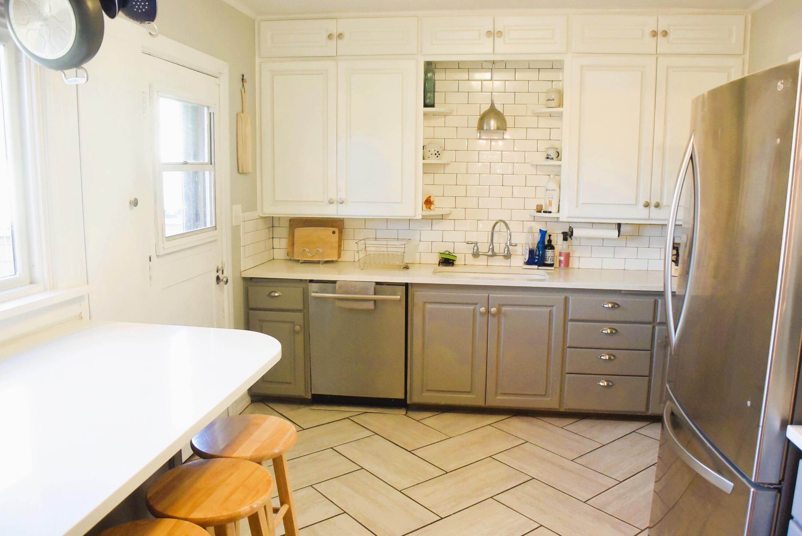 2508 24th Street Lubbock, TX 79410 - Photo 7 of 14 a kitchen with a sink a window and cabinets