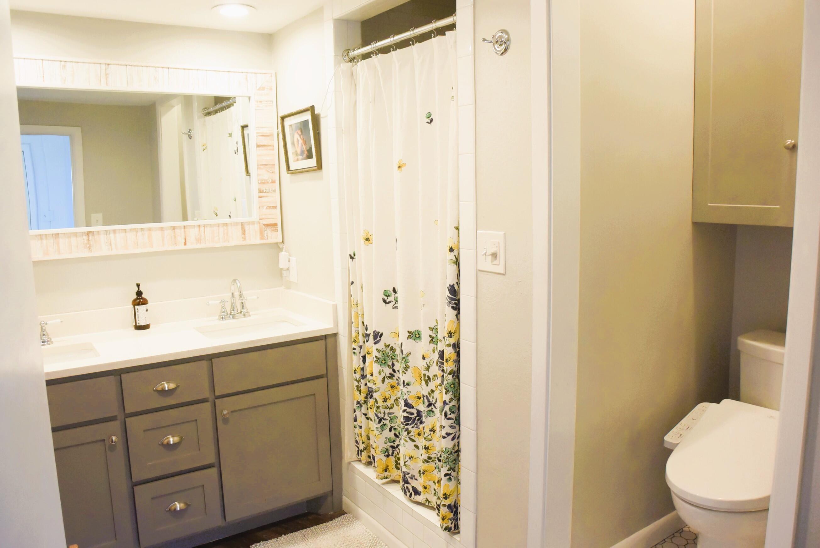 2508 24th Street Lubbock, TX 79410 - Photo 9 of 14 a bathroom with a sink a toilet and shower