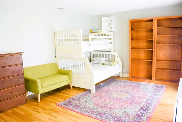 a living room with a couch and a rug